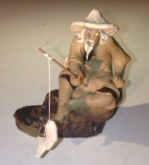 Ceramic Figurine Mud Man Sitting On A Rock Fishing